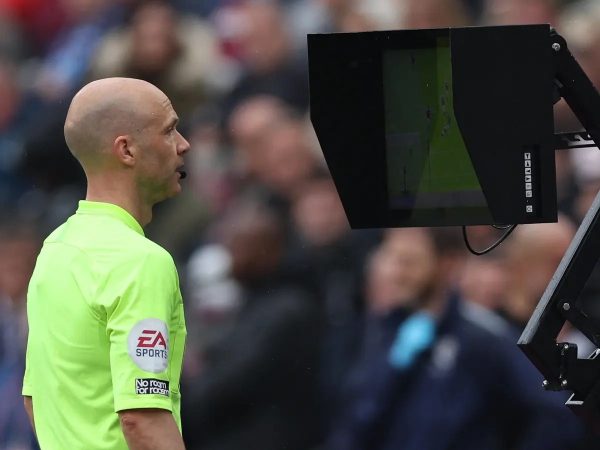Referee looking at the VAR monitor